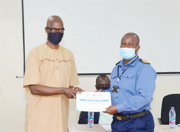Professor Kwaku Osei-Hwedie, Dean of Academic Affairs, Kofi Annan International Peacekeeping Training Centre (left), presenting a certificate to one of the participants
