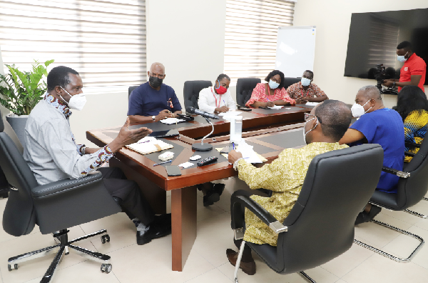 Dr Yaw Osei Adutwum (left), Minister of Education, holding discussions with Mr Ato Afful (2nd left), Managing Director of the Graphic Communications Group Limited, and his entourage during a courtesy call in Accra