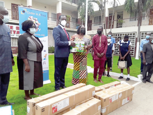 • Dr Yaw Osei Adutwum (2nd left), Minister of Education, presenting the robotic kits to Madam Alice Prempeh-Fordjor, Headmistress of Aburi Girls