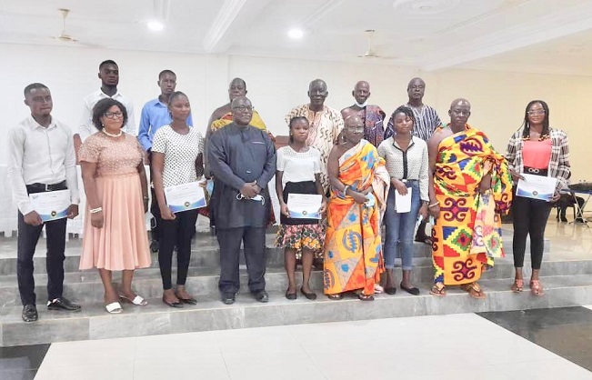 A section of the scholarship beneficiaries in a group photograph with dignitaries at the function