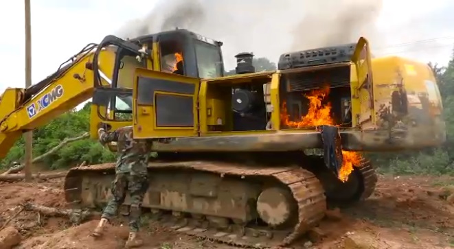 An excavator set ablaze at a galamsey site