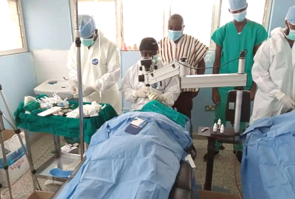 Residents being attended to by a medical officer, while Mr Dzudzorli Kwame Gakpey, MP for Keta (in smock) and other staff of the hospital look on
