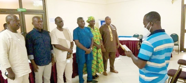 • Mr Isaac Kpegba Cobblah, an official of the Electoral Commission swearing-in the newly elected executive. Standing (3rd right) is Mr Francis Nii Boye Tagoe