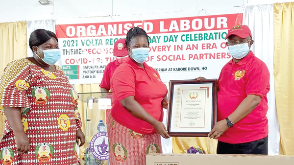 Dr Archibald Yao Letsa presenting a citation to Madam Francisca Adzo Osei (middle) for being the best regional personality. With them is Edith Amenuvor Afewu (left), the acting Volta and Oti TUC Secretary