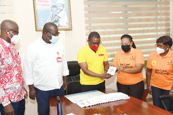 Mrs Josephine Nkrumah (right), Chairperson of the NCCE, presenting copies of the Constitution to Mr Kobby Asmah (2nd right), Editor of the Daily Graphic. Looking on are Mr Theophilus Yartey (2nd left), Deputy Editor, and Mr Albert Salia (left), Political Editor, both of the Daily Graphic. Picture: EBOW HANSON 