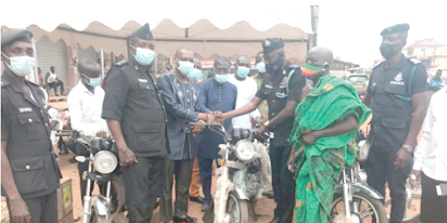  Chief Superintendent Yaw Asubonteng (3rd right), Abuakwa District Police Commander,  receiving one of the motorbikes from Dr Kingsley Nyarko (3rd left), MP for Kwadaso