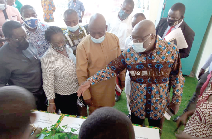 Dr Kwaku Afriyie (right), Minister of Environment, Science, Technology and Innovation, inspecting some of the new yam varieties
