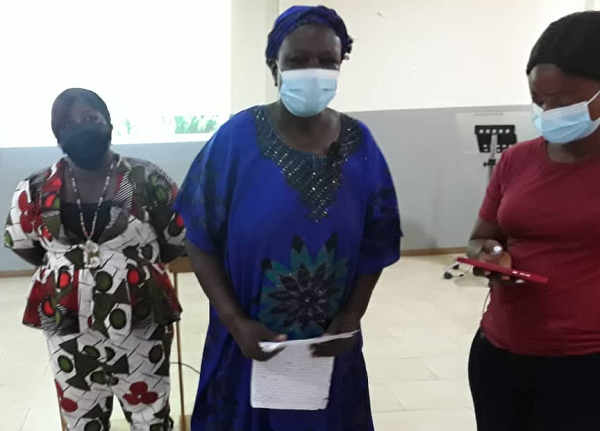 The Upper East Regional Secretary of Women in Agriculture Platforms(WAPs -in the middle),Ms Gilberta Akuka addressing the forum