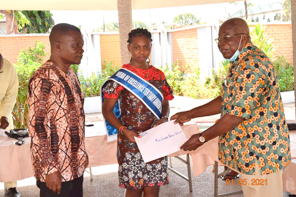 Dr Gabriel Ofoe Canacoo (right), Chairman of Administrators of the Webb of Excellence Welfare Fund, presenting the award to Miss Esther Pamela Partey. With them is Mr Kojo Ayibor, Headmaster of Ada Senior High School