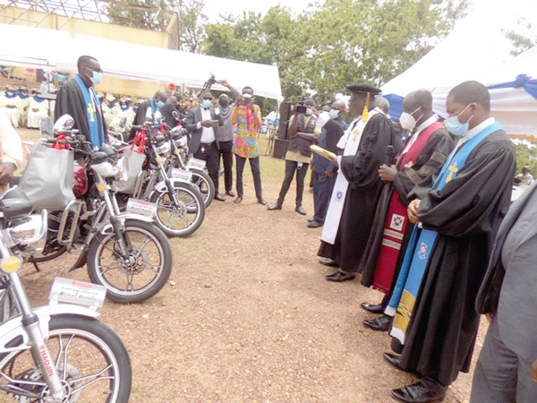 Rt Rev. Prof. J.O.Y Mantey (arrowed), Moderator of the General Assembly of the Presbyterian Church of Ghana, praying over the motorbikes for the beneficiary pastors