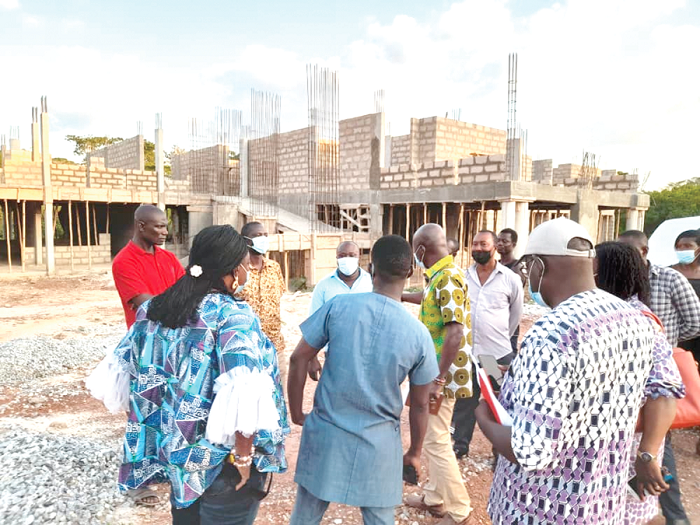 Nii Lante Vanderpuye (arrowed), Ranking Member of the Local Government Committee of Parliament, and other members of the committee at the site of the administration block of the Berekum District Assembly at Jinijini