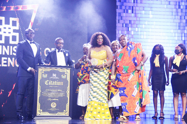  Mrs Catherine Afeku (2nd right), a former Minister of Tourism, being presented with a memento and a citation by Mr Augustine Arhinful, an ex-Black Stars player. 