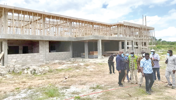 Members of the committee inspecting the construction of a two-storey administration block for the Ahafo Regional Health Directorate at Hwediem