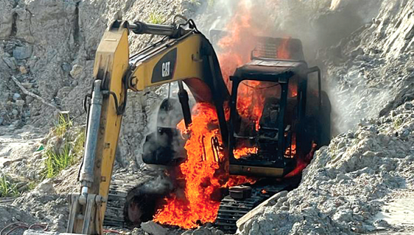 One of the many excavators being burnt