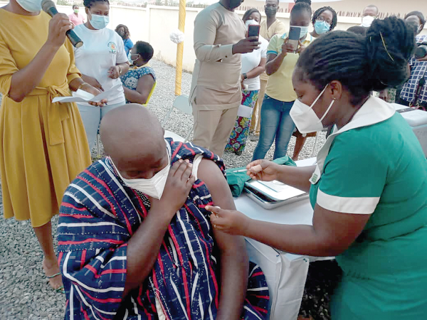 A nurse vaccinating a member of the public