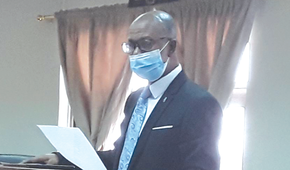 Justice Kofi Akrowiah administering the oath of office to the commissioners