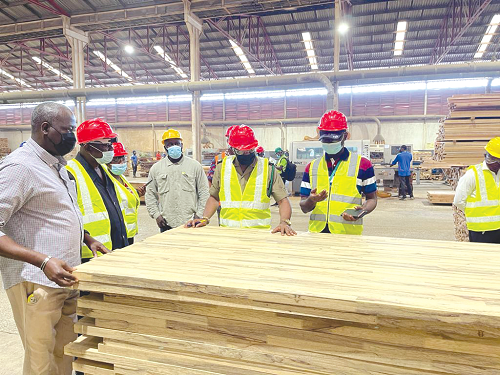 Dr Kokofu (2nd right), CEO, EPA, being conducted round some of the finished plywood by Mr Richard Kuagbela (2nd left) the Managing Director of L.L.L. Company