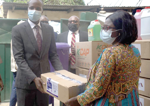  Mr Robert Wugah (left), MD, Imperial General Assurance, presenting the items to Ms Francisca Yengeh, Headmistress, Rashad Islamic Basic School AT Mallam Atta 