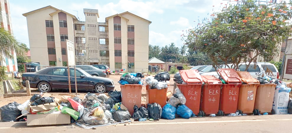 Overflowing waste bins at the Adenta SSNIT Flats