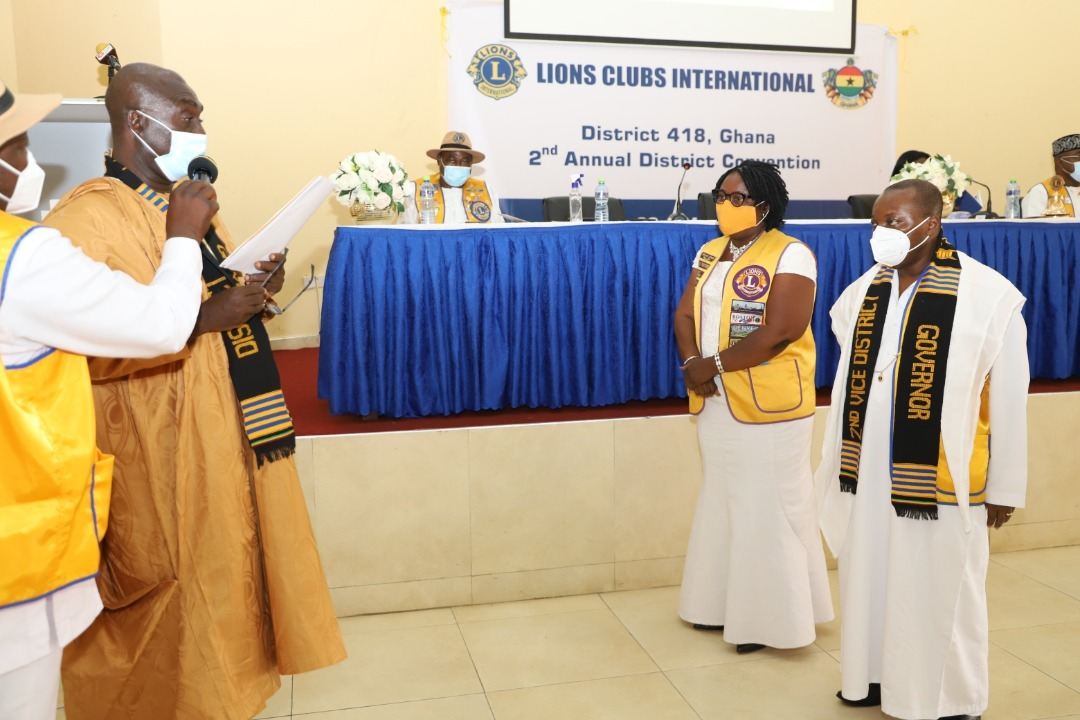 Lion David Owusu Anokye (left), in-coming Governor, swearing-in Lion Emmanuel Kojo Gyimah (right), First Vice District Governor and Lion Kate Baaba Hudson (second right), Second Vice District Governor into office. PICTURES BY GABRIEL AHIABOR