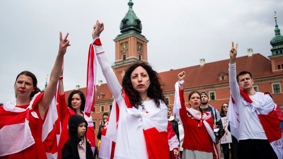 The crowd at the Warsaw demonstration waved the Belarusian opposition's red and white flag