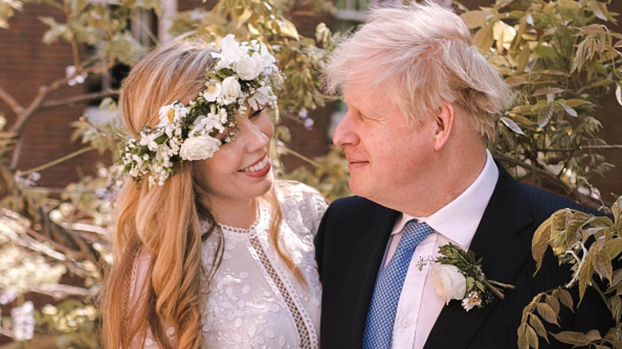 Prime Minister Boris Johnson poses with his wife Carrie Johnson in the garden of 10 Downing Street following their wedding at Westminster Cathedral on Sunday.