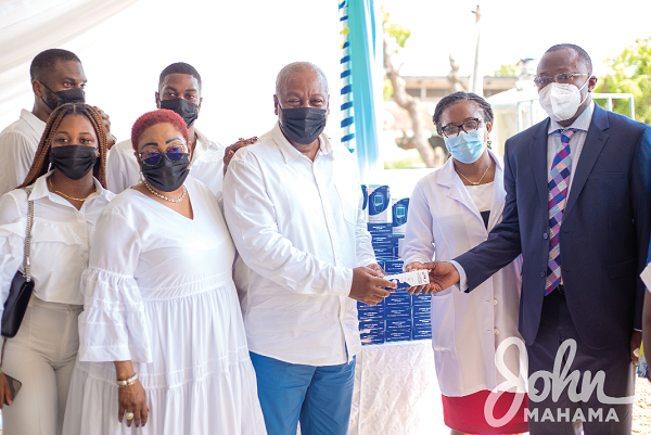 Mr Mahama presenting a glucometer to Dr. Opoku Ware Ampomah, Chief Executive of Korle Bu Teaching Hospital