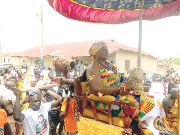 Nana Bamfoa Konadu Yiadom in a palanquin being paraded through the principal streets of Anyinam Kotoku