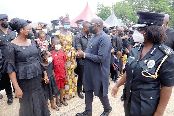 Vice-President Dr. Bawumia consoling some widows and thier children after the ceremony.  On his left is DCOP Habiba Twumasi Sarpong, Director-General, Welfare, Ghana Police Service