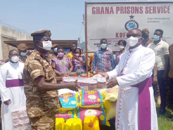 Rt. Rev. Felix Odei Annancy (right), Bishop of the Koforidua Diocese of the Anglican Church, presenting the items to Superintendent Nana Osafo Suronipa, the Officer in charge of Service of the Koforidua Prisons, on behalf of the inmates last Friday