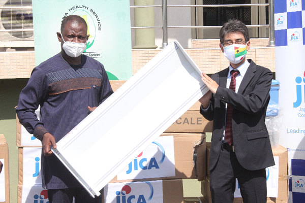 Mr Araki Yasumichi (right), Chief Representative of JICA Ghana Office, presenting the equipment to Dr Patrick Kuma-Aboagye, Director-General of GHS.  Picture: PATRICK DICKSON
