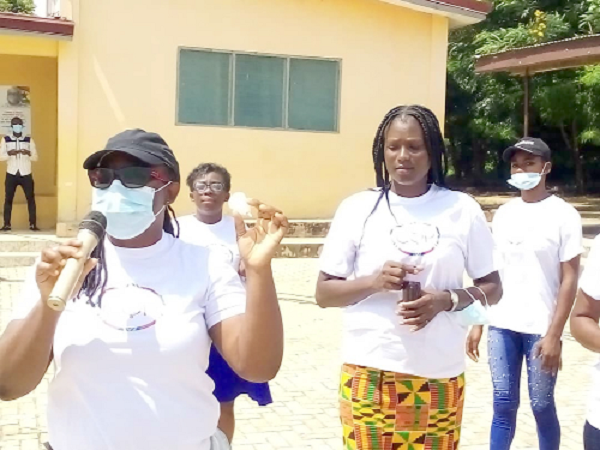 Madam Anna Sefakor Dotse (left), Project Nurse of the Could You?, demonstrating to the schoolgirls how the new menstrual cup works 