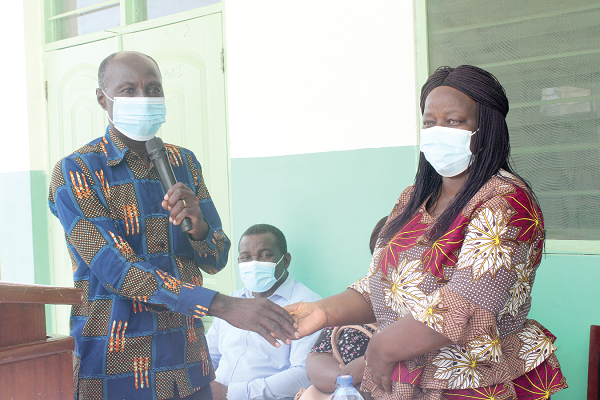 Mr Edward Ansah (left), Engineer of Ecobuild Consult, handing over the keys of the newly constructed six-unit classroom block to Ms Pearl Bruce, the Headmistress of Kaneshie Senior High Technical School. Picture: Patrick Dickson 