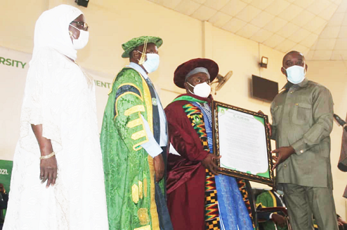  Dr Ahmed Abdulai Jinapor (right), Deputy Director of the Ghana Tertiary Education Council, presenting the citation to Naa Alhassan Andani, while Prof. Wayo Seini (left) looks on