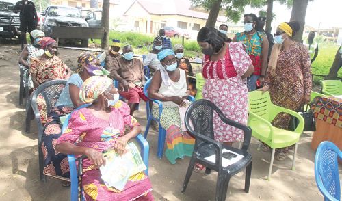 Mrs Cecilia Abena Dapaah (2nd right), the Caretaker for the Ministry of Gender, Children and Social Protection, having  a conversation with some beneficiaries at the LEAP payment at Amamorley.  Picture: ESTHER ADJEI 