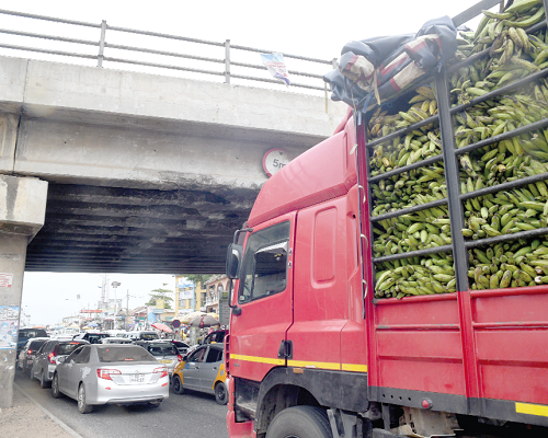 An overloaded truck passing under the Abofu Bridge at Achimota in Accra. Picture: emmanuel quaye