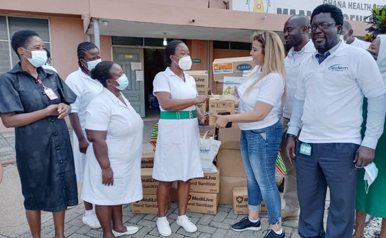 Ms Rasha Oudeh, CEO of CEDEM AG, (right) presenting the items to Ms Mary Yost (left) a Principal Nursing Officer at the Mamobi Polyclinic