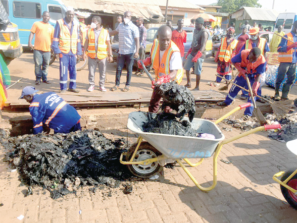Some members of the Graphic/Zoomlion team and some volunteers engaged in the clean-up exercise in the Central Business District in Tamale