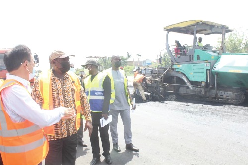 Mr Du Honglai (left), the Project Manager, briefing Mr Kwasi Amoako Attah (2nd from left), Minister of Roads & Highways, on the ongoing road construction at Kwafokrom on the Accra-Kumasi highway. Picture: Patrick Dickson