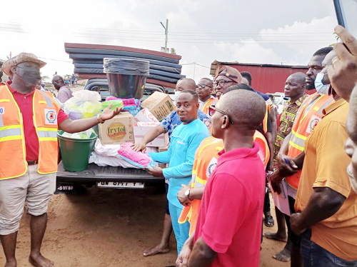  Mr Emmanuel Gemegah (arrowed), the Keta MCE, readies items for onward distribution