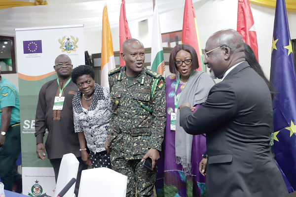 Mr Alcide Djedje (right), Minister Delegate in charge of African Integration, Cote d'Ivoire; Mr Kwame Asuah Takyi (3rd from left), Comptroller-General of the Ghana Immigration Service; Mrs Adelaide Anno-Kumi (2nd from left), Chief Director of the Ministry of the Interior, and other delegates interacting after the ceremony. Picture: EDNA SALVO-KOTEY