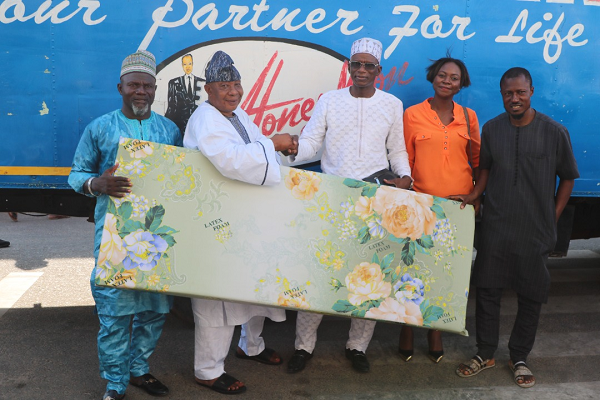 The Export Manager of Latex Foam, Dr Yakubu Diomande (middle) supported by the Public Relations Officer of the company, Ms Gifty E. Appiah (2nd right) presenting a sample of the mattress to the Chief Protocol Officer at the Office of the National Chief Imam, Alhaji Latif Abdulsalam (2nd left) with other officials from the Chief Imam's office looking on. 