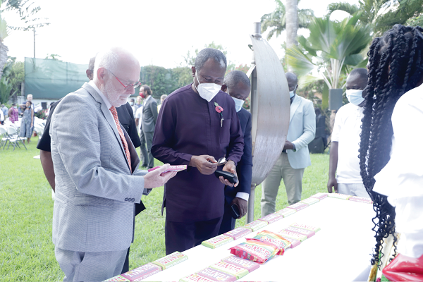 Mr Jeroen Verheul (left), Netherlands Ambassador to Ghana, and Mr Joseph Boahen Aidoo (right), Chief Executive Officer, COCOBOD, examining some cocoa products during an exhibition at the event. Picture: EDNA SALVO-KOTEY