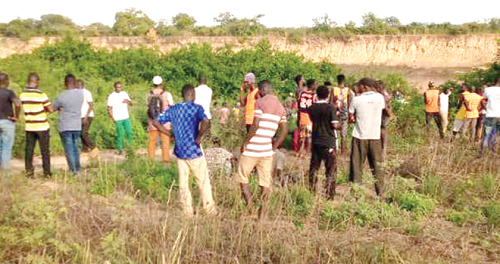  Some community members at the riverside searching for the bodies of the students