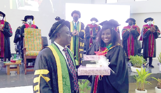 Ms Elizabeth Naa Abiana Morton (right) receiving one of her nine awards from Prof. John Owusu Gyapon, Vice-Chancellor of UHAS