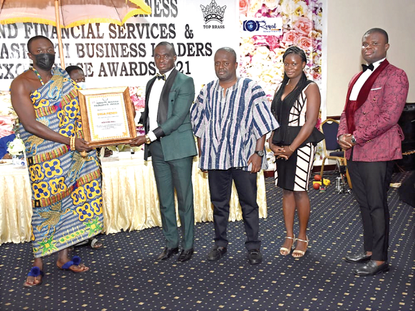 Nana Agyekum Kusi Ababio, Otumfuo’s representative at the ceremony and Oyokohene (left), presenting the Gold award to the CEO of Western Mall, Mr Isaac Owusu