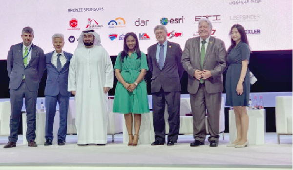 Ms Mavis Nkansah-Boadu (middle), Deputy Minister of Roads and Highways, with some officials at the exhibition in Dubai