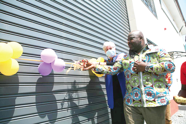 Ms Stephanie Sullivan, the Ambassador of the United States to Ghana, and Mr Michael Okyere Baafi, a Deputy Minister of Trade, cutting a ribbon to officially open the air-conditioning and refrigerator test laboratory in Accra