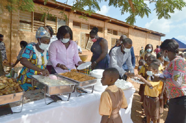 Mrs Justina Marigold Assan (2nd from left), Central Regional Minister, serving food to some pupils of the Swedru Salvation Army School for the Deaf