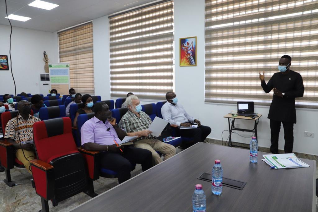 Dr Julius Ahiekpor(standing right), speaking at the workshop in Kumasi.